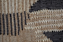 Close-up of the Birala Large Textured Wall Art by nkuku, handwoven with tan, cream, and dark blue threads in vertical stripes and angled shapes, showcasing intricate Indian-inspired design on a textured background.