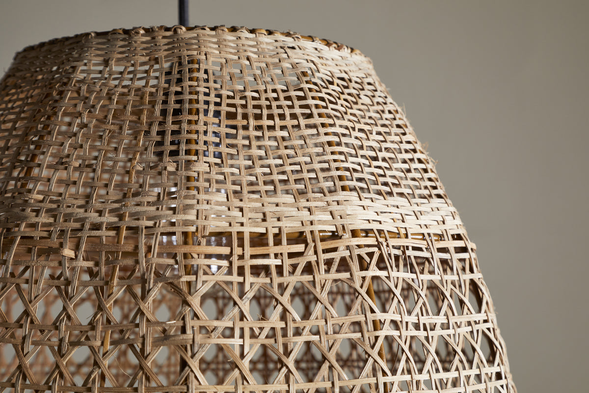 Close-up of the Shawa Rattan Lampshade - Natural by nkuku, showcasing its handwoven crisscross and lattice design. The neutral background highlights the airy texture and artisan craftsmanship of this organic lighting piece.