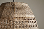 Close-up of the Shawa Rattan Lampshade - Natural by nkuku, showcasing its handwoven crisscross and lattice design. The neutral background highlights the airy texture and artisan craftsmanship of this organic lighting piece.