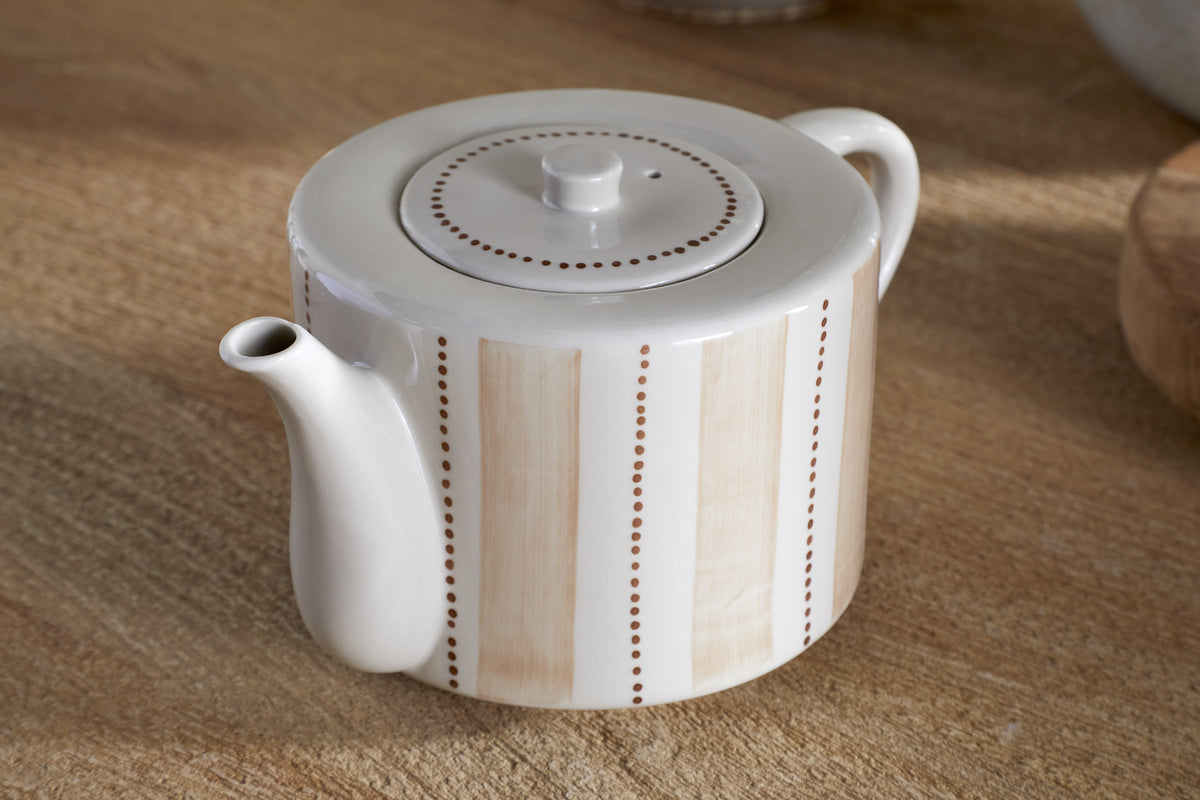 The nkuku Patthar Teapot - Cream & Clay - Large features hand-painted vertical beige stripes and dotted brown lines on a cream base, with a round lid, short curved spout, and large handle—showcasing traditional craftsmanship.