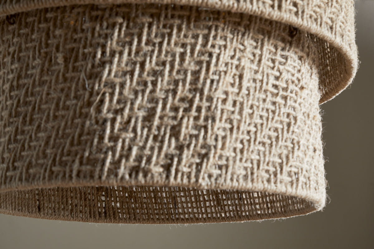 Close-up of the nkuku Thimba Woven Jute Chandelier in Natural, featuring a textured jute shade with intersecting fibers. The rustic weave allows gentle light to filter through, highlighting its organic charm.