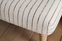 Close-up of the nkuku Sanja Stripe Upholstered Bench - Grey, showcasing cream and black striped natural cotton upholstery, a light wooden leg, and positioned on a wooden floor.