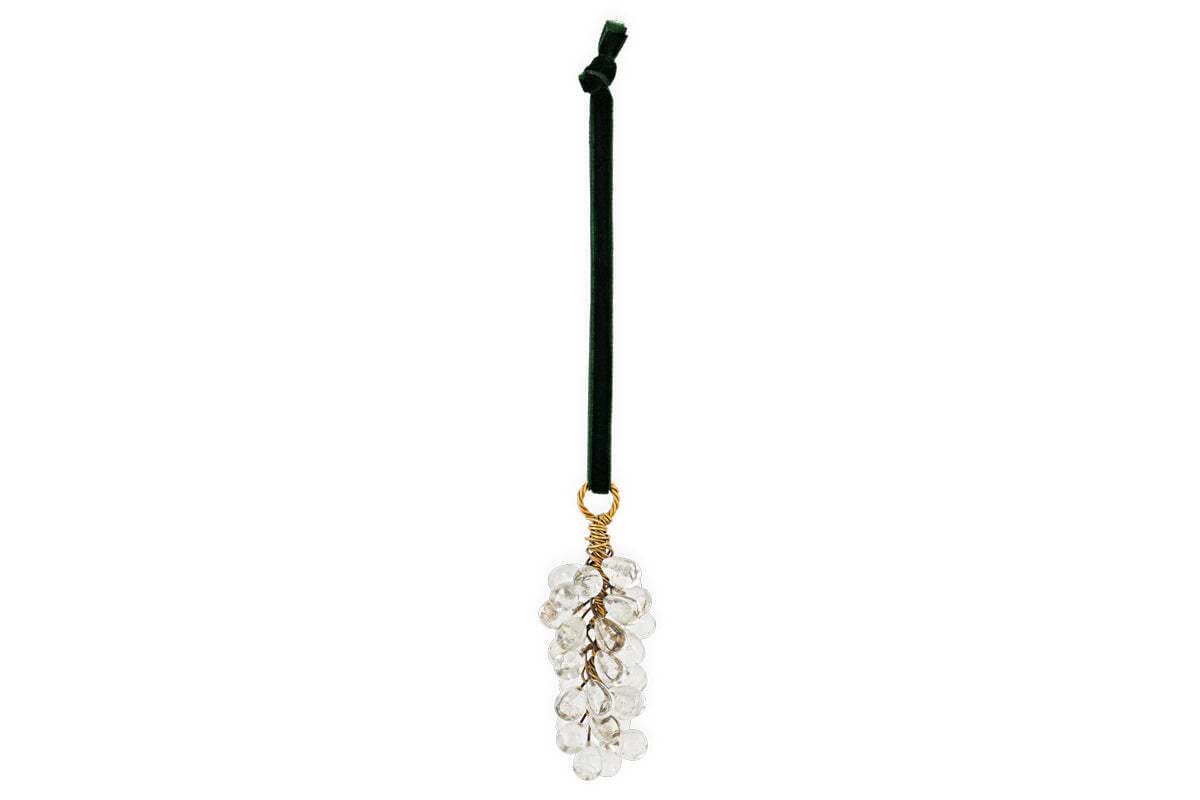 The nkuku Danvi Glass Drop Baubles - Brass & Clear (Set of 3) feature clear glass drops on gold wire, evoking grape clusters. Finished with a green velvet tie for easy hanging, their elegant, minimal design enhances any Christmas tree.