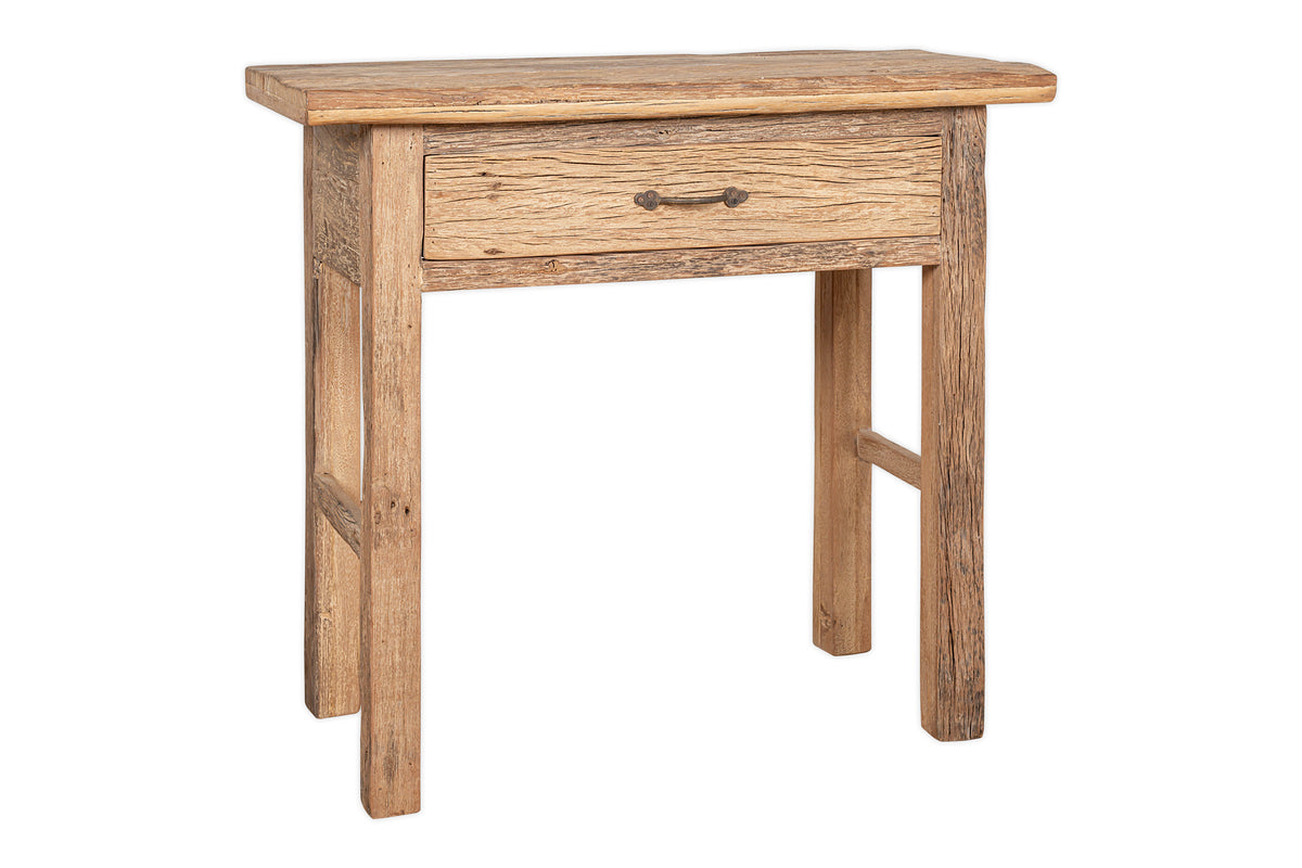 The Ibo Reclaimed Wood 1 Drawer Console Table by nkuku features a slim, rustic design with natural textured grain, a central metal-handled drawer, and is perfect for adding charm to any entryway.