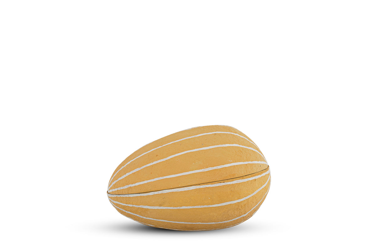 The Surya Recycled Cotton Paper Side Opening Egg by nkuku features an ochre, oval design with creamy white stripes—perfect for Easter tables or gifting. It’s shown on a white background with a soft shadow below.