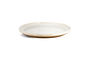 The Edo Dinner Plate - Terracotta by nkuku is a round ceramic plate with a raised rim, off-white glaze on top, and natural brown edges and bottom. Its minimalist design adds simple elegance to your table.