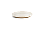 The nkuku Edo Dinnerware Set - Terracotta (Set of 12) features shallow, round ceramic plates with glossy white interiors and rims, contrasted by matte unglazed brown bases for a modern, earthy look, shown against a plain white background.
