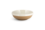 The Edo Dinnerware Set - Terracotta by nkuku features a shallow ceramic bowl with a matte tan exterior and glossy white interior—minimalist, modern, and perfect for any elegant table setting. Set includes 12 pieces.
