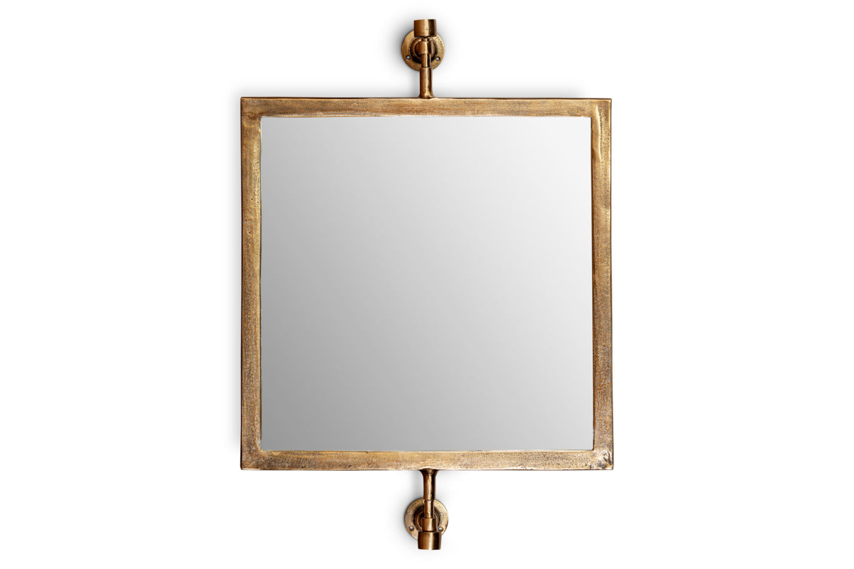 The nkuku Visala Swivel Wall Mirror in Antique Brass features a rectangular design, gold metallic frame, and two round mounts. Its clear reflective surface adds stylish elegance to any space.