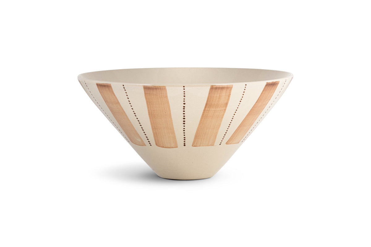 The nkuku Patthar Serving Bowl - Cream & Clay - Medium is a cream-colored, cone-shaped ceramic bowl with hand-painted vertical clay stripes and dotted lines, evenly spaced around its exterior. Styled against a plain white background.