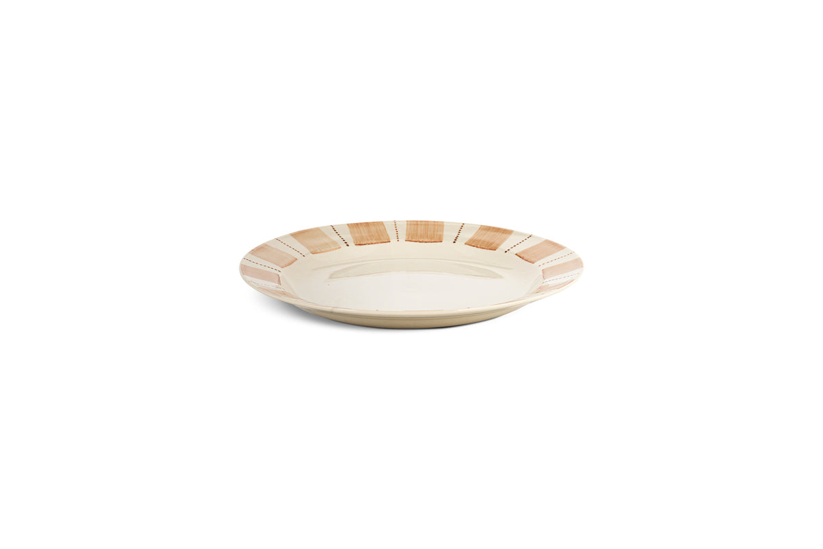 The nkuku Patthar Side Plate - Cream & Clay features a hand-painted wide rim with alternating tan and cream stripes and a plain cream center, creating an elegant ceramic addition to your table.