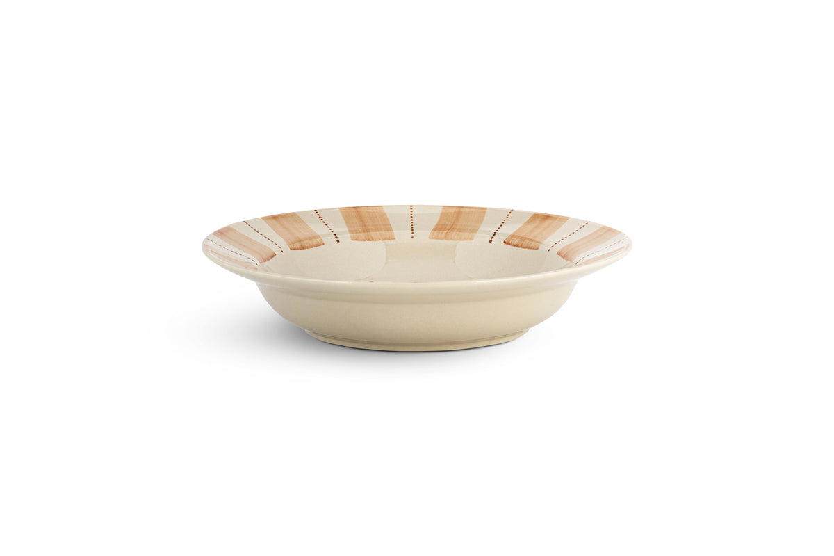 The nkuku Patthar Pasta Bowl - Cream & Clay features a shallow, round ceramic design with a wide rim accented by alternating tan and beige stripes and dotted lines, adding rustic charm to your dinnerware. Shown on a plain white background.