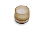 The nkuku Oakmoss & Rose 1 Wick Scented Candle - Yellow sits in a rustic, hand-blown glass holder with a warm beige-to-brown gradient, shown against a plain white background.