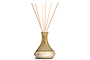 The nkuku Oakmoss & Rose Scented Reed Diffuser - Yellow features a hand-blown glass vessel with a narrow neck and gold-brown finish, infusing any room with rustic charm and a gentle floral fragrance.