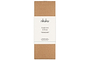 A rectangular brown cardboard box with a white band featuring the nkuku logo showcases the Oakmoss & Rose Scented Reed Diffuser – Yellow, known for its elegant floral and woody fragrance.