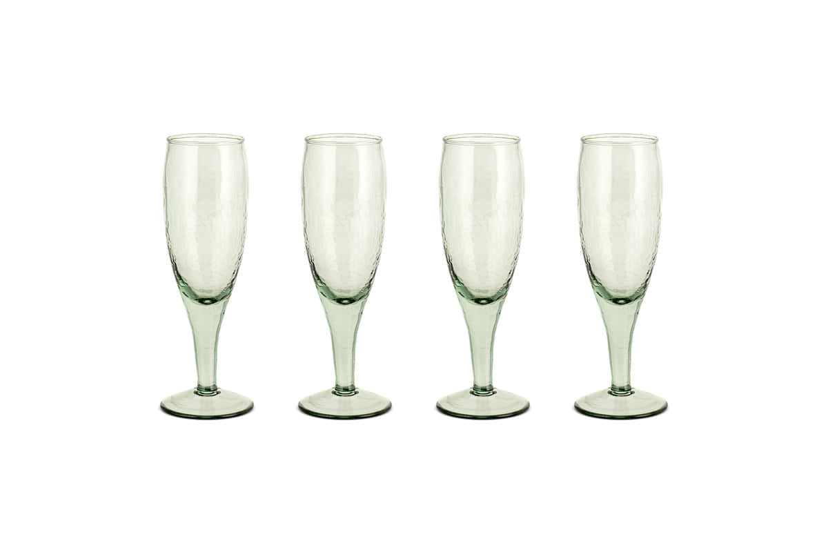 The nkuku Yala Hammered Champagne Glasses (Set of 4) in sage green feature textured, hammered glass and are shown side by side on a white background.