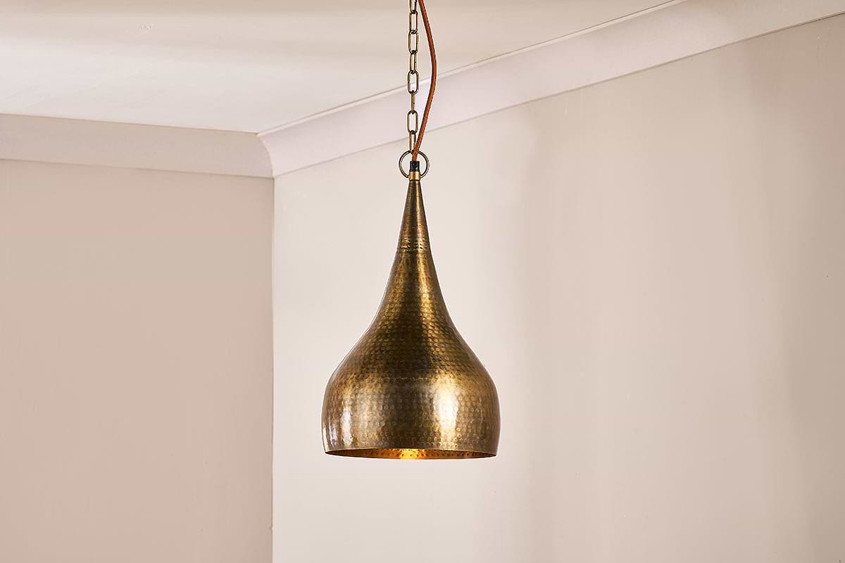 Hammered store metal pendant