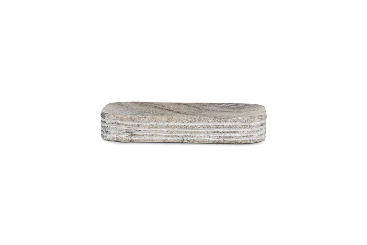 The nkuku Asana Marble Soap Dish in grey features hand-etched marble texture, rounded corners, and horizontal side grooves for a layered look. This rectangular tray is part of the Asana Marble Collection.