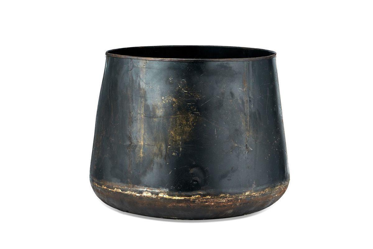 The Endo Reclaimed Iron Planter by nkuku is a wide, cylindrical black pot crafted from reclaimed iron with a matte finish, featuring rustic scuffs, gold and brown accents near the base—perfect as a unique garden planter against white backgrounds.