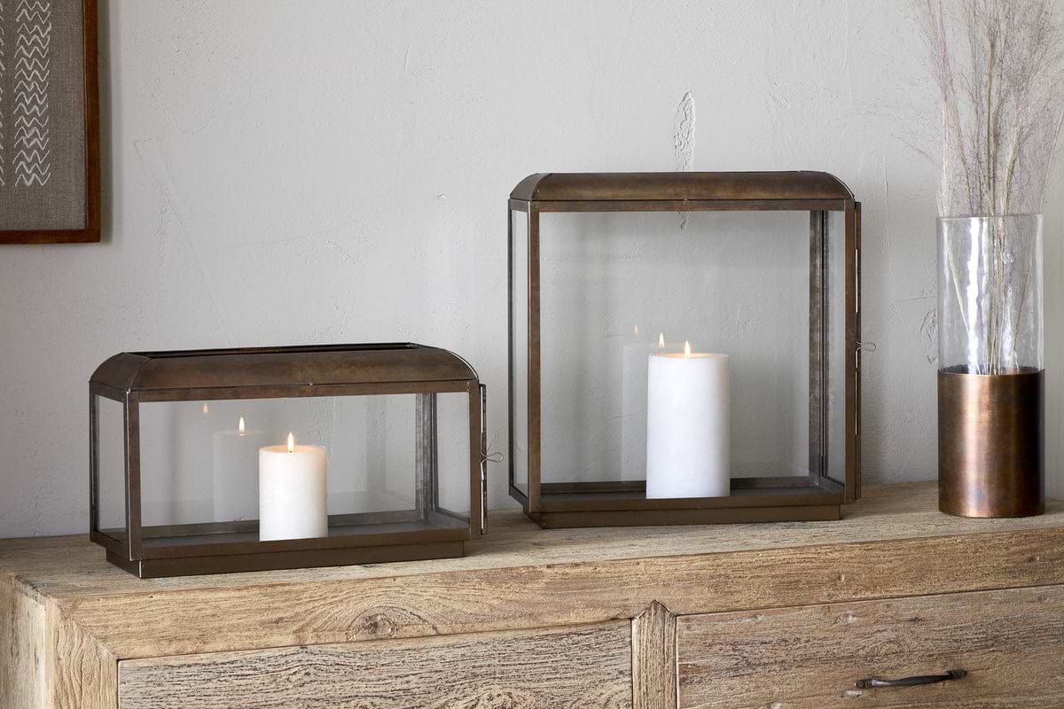 The nkuku Kiwanda Wide Lantern in Antique Brass brings elegant candlelight décor, seamlessly blending timeless charm with modern style.