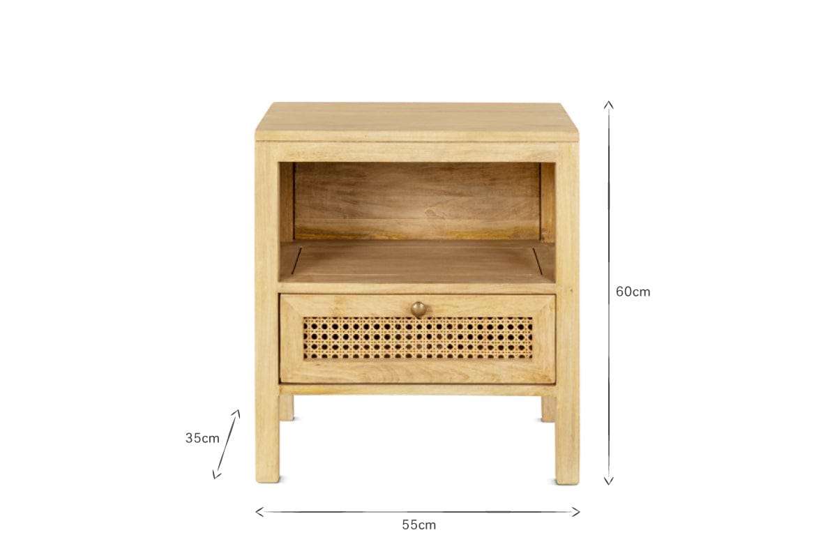 The nkuku Kanz Mango Wood Bedside Table features an open shelf above a drawer with a handwoven cane front and round brass knob. Sized at 55cm W x 35cm D x 60cm H, it’s a stylish, sustainable choice for your bedroom.