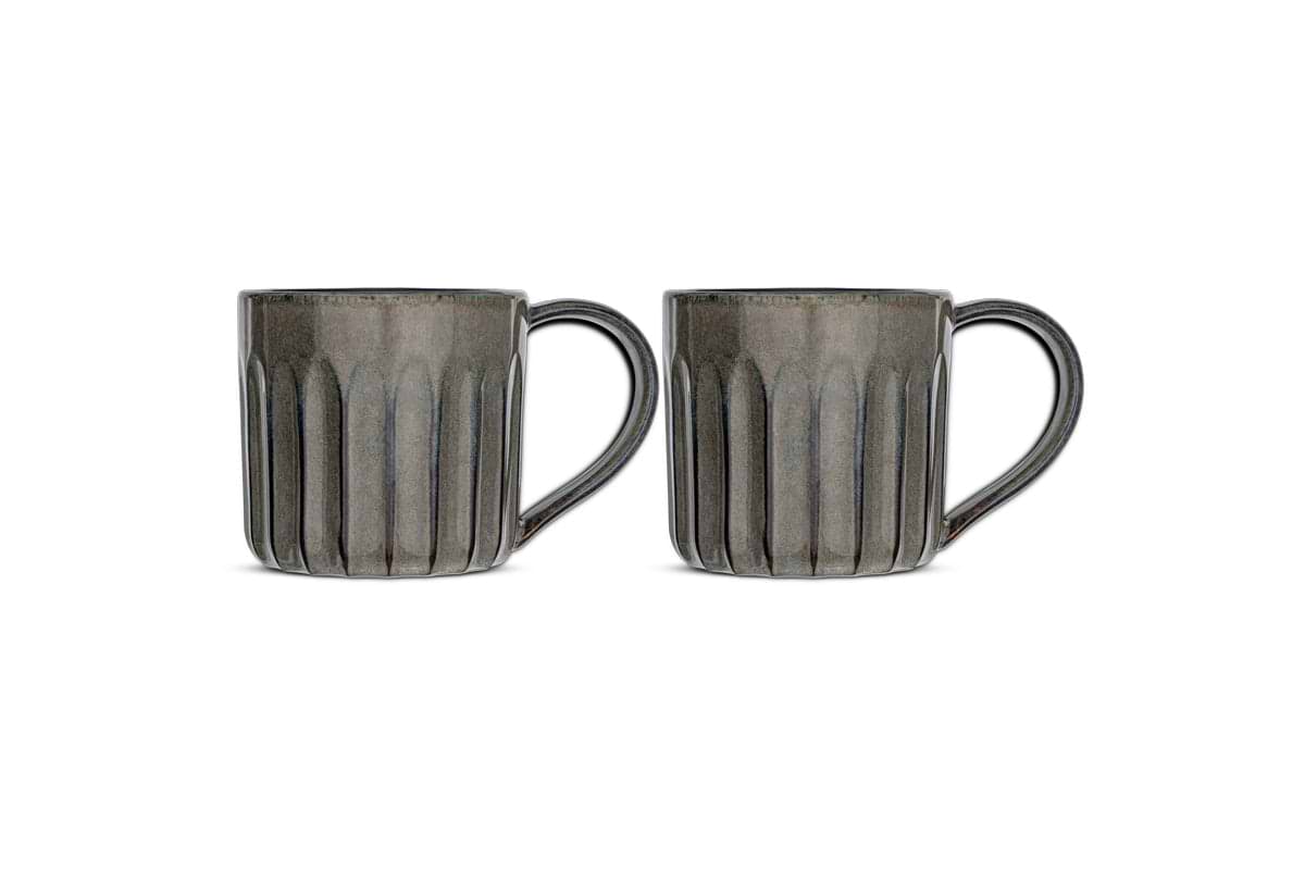 The Moda Mug - Pewter (Set of 2) by nkuku features two gray ceramic mugs with vertical ribbed texture, large rounded right handles, and glossy finish—all shown side by side against a white background.