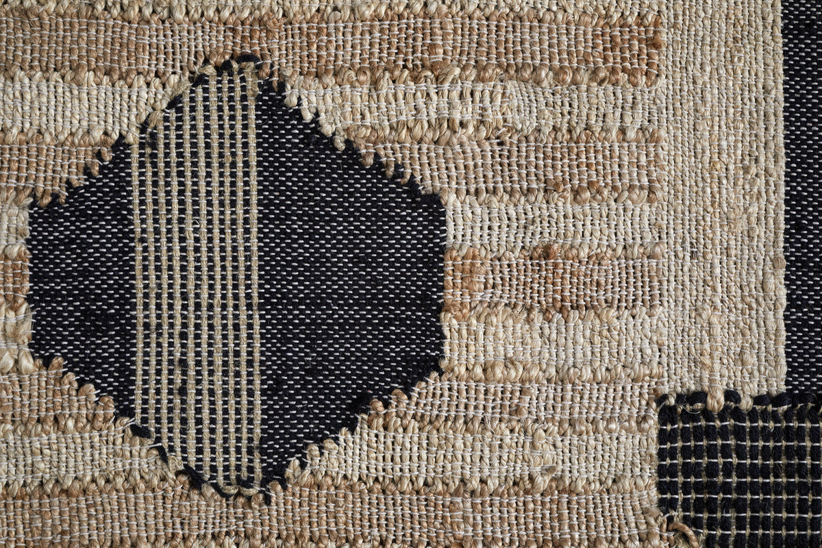 Close-up of the Kiran Large Textured Wall Art by nkuku. Handwoven with beige and brown stripes, its natural and dark blue geometric lines form bold diamond shapes, making it a striking abstract motif for modern wall decor.