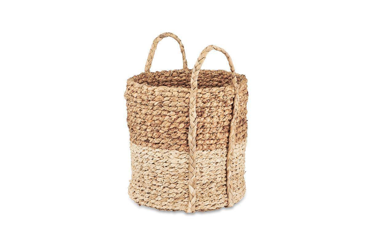The nkuku Nkomi Basket is a handwoven storage basket with two handles, made from natural fibers. It features a stylish two-tone design with a dark tan upper half and lighter beige bottom, all set against a white background.