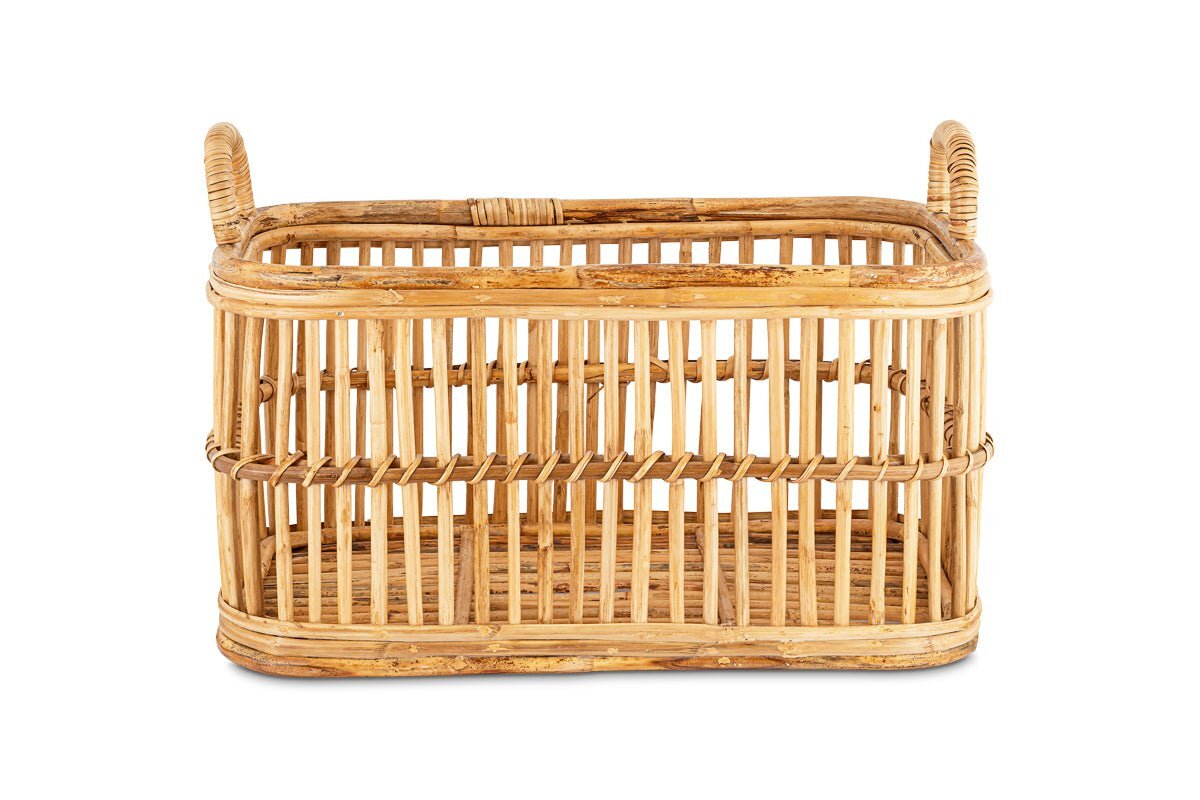 The nkuku Rammi Rattan Laundry Basket is a rectangular, light brown storage basket with two handles, vertical slats, and a woven base. Its natural rattan texture stands out against a plain white background.