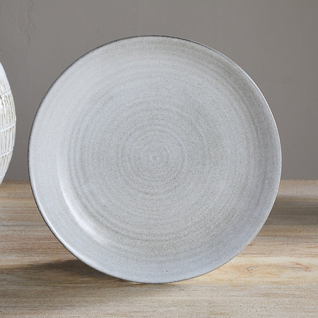 The Valinha Earthenware Dinner Plate in grey by nkuku features a smooth finish, making it perfect for enhancing any tableware collection.