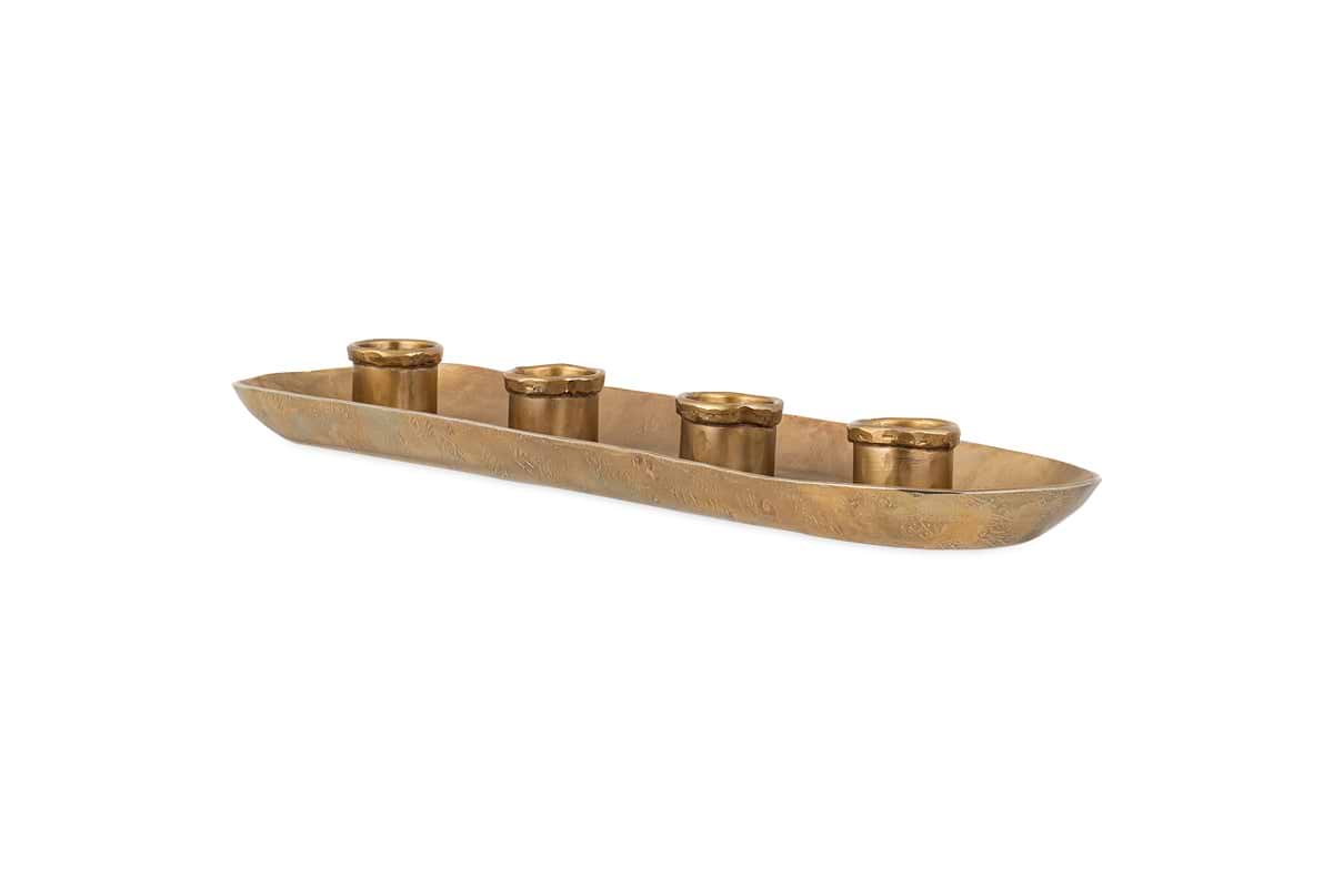 The nkuku Amita Long Candle Holder in antique brass features a textured, brushed oval tray with five evenly spaced cylindrical holders, creating an elegant and minimalist centrepiece for your dining table.