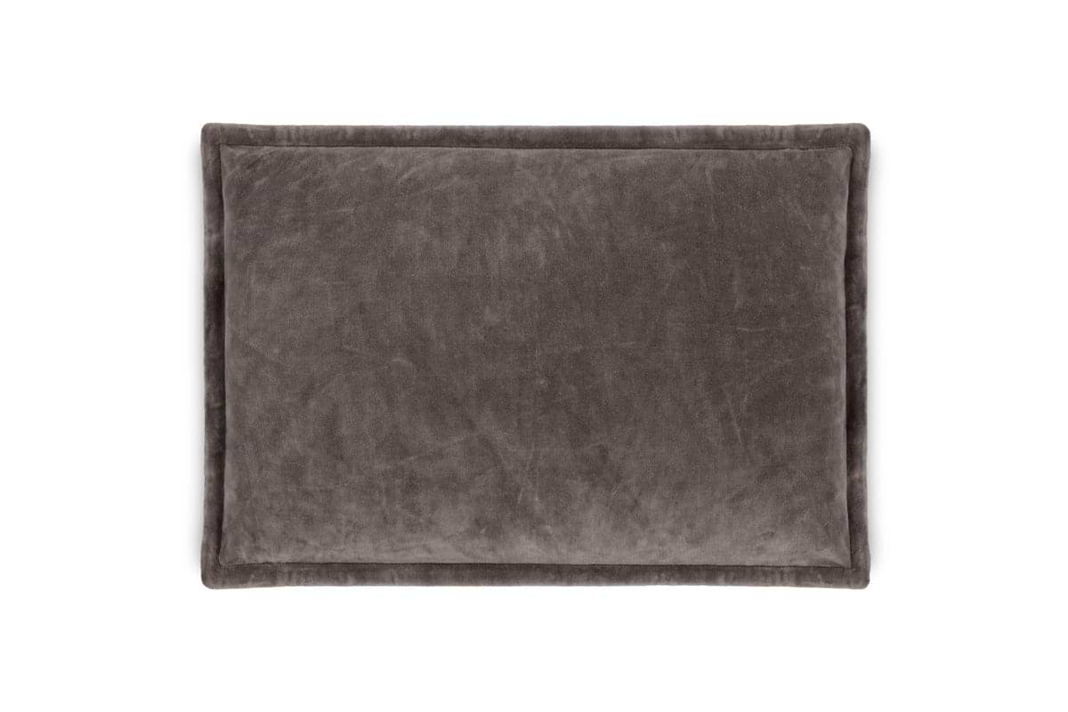 The nkuku Dhara Velvet Cushion Cover in charcoal is a rectangular, dark gray decorative cover with a soft, plush texture and slightly raised edges, offering stylish comfort for any space. Shown here against a white background.