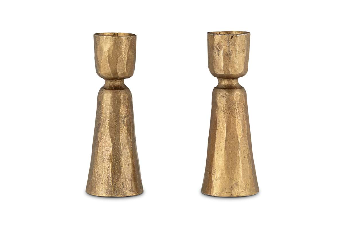The nkuku Lokoja Candle Holder - Antique Brass (Set of 2) features gold-colored, textured holders with hammered detail—perfect for adding elegance to any table setting.