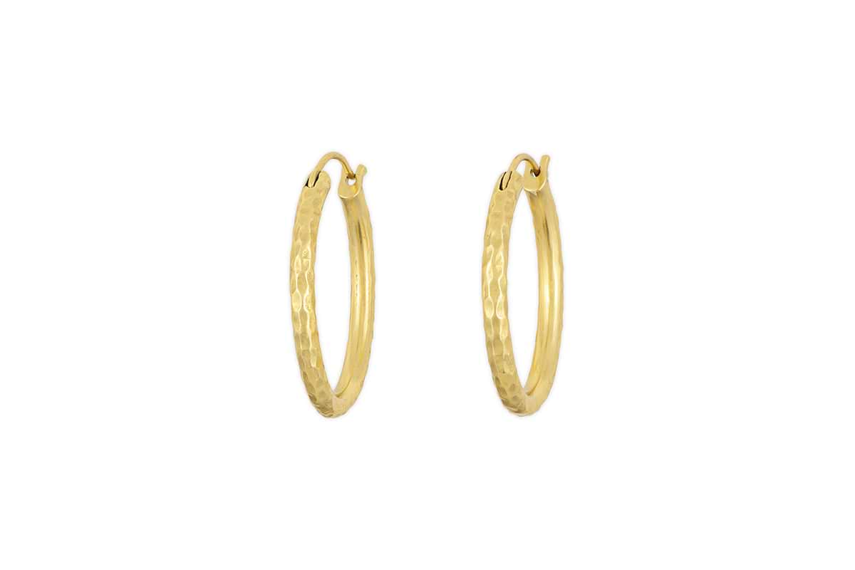 The Labani Earrings - Gold by nkuku feature a timeless hammered texture and are showcased against a white background.