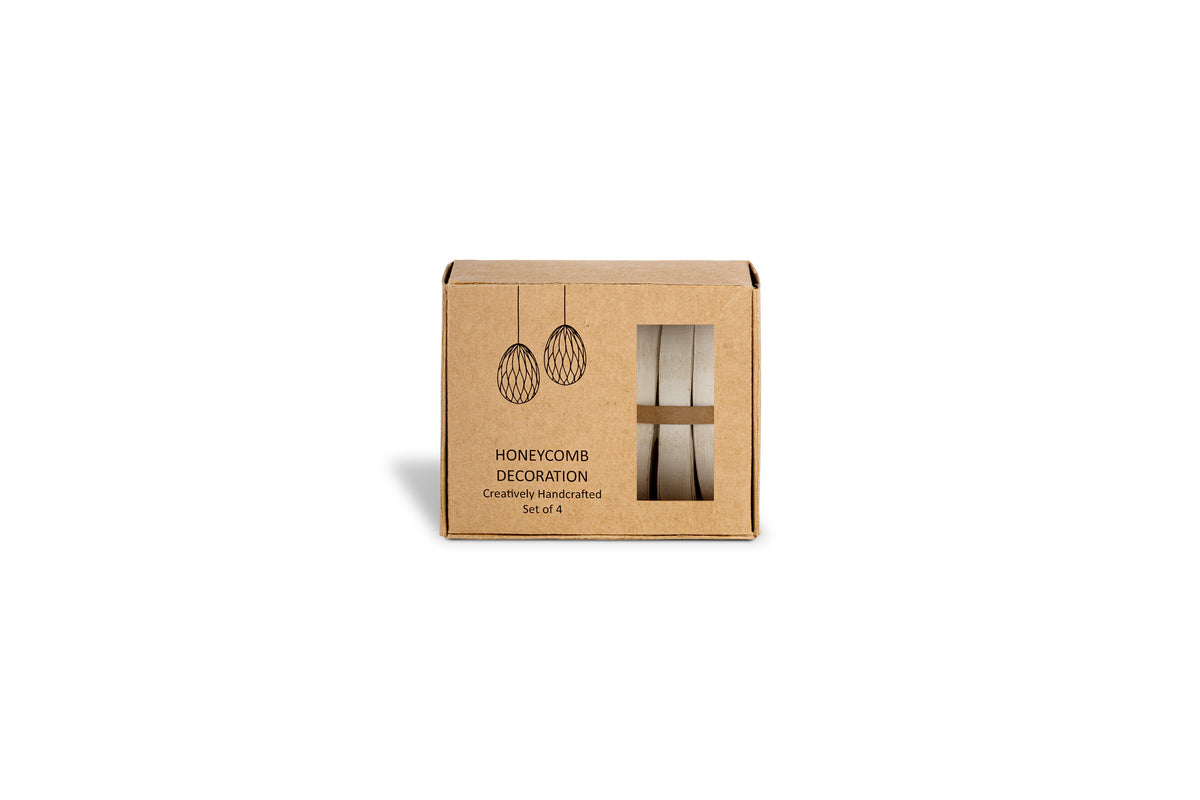 A small cream box labeled Piani Hanging Paper Decoration by nkuku, Set of 4, rests on a white background. The packaging displays hanging paper décor and a window revealing the handcrafted decorations inside.