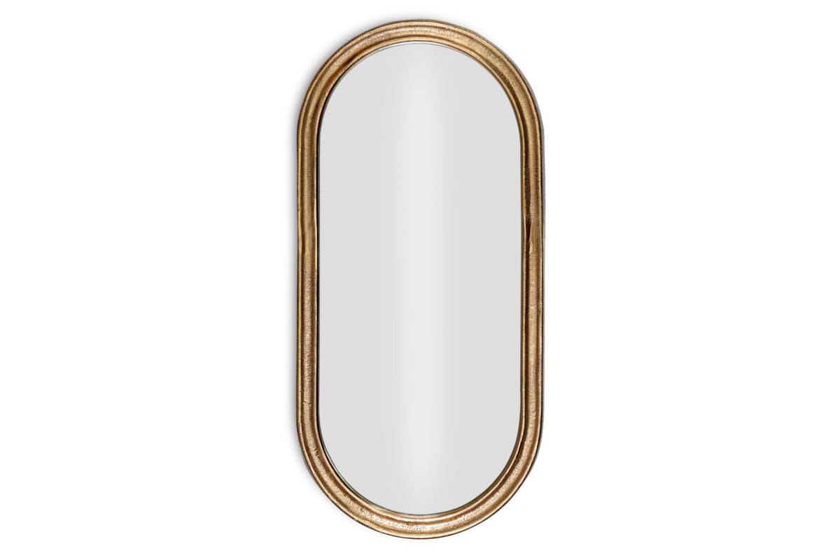 The Mbwa Oval Mirror by nkuku features a reflective surface and an antique brass, textured frame, shown against a plain white background.