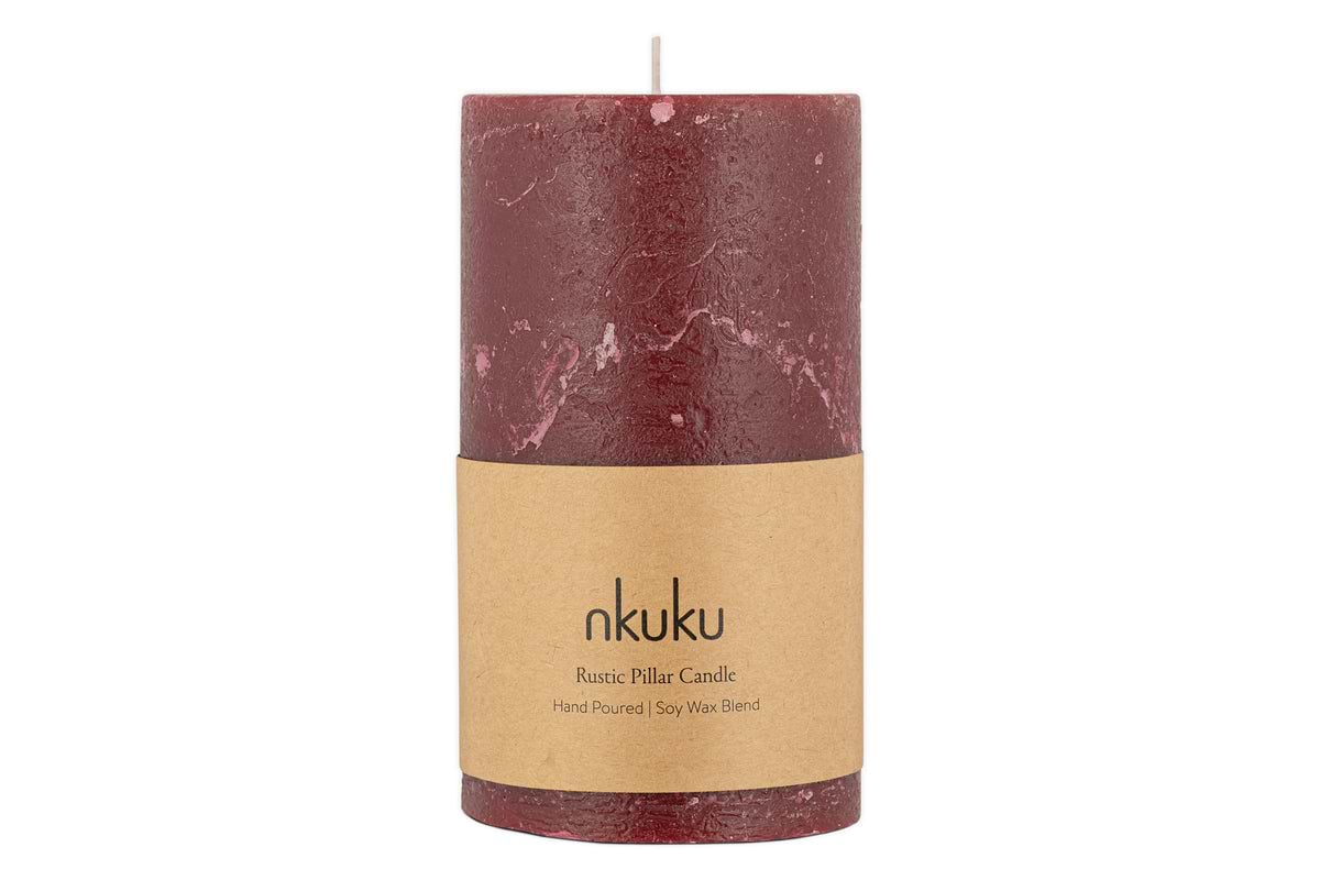 The nkuku Rustic Soy Blend Pillar Candle - Dark Cherry - Large features a beautifully textured finish and a brown paper label reading nkuku Rustic Pillar Candle Hand Poured | Soy Wax Blend.