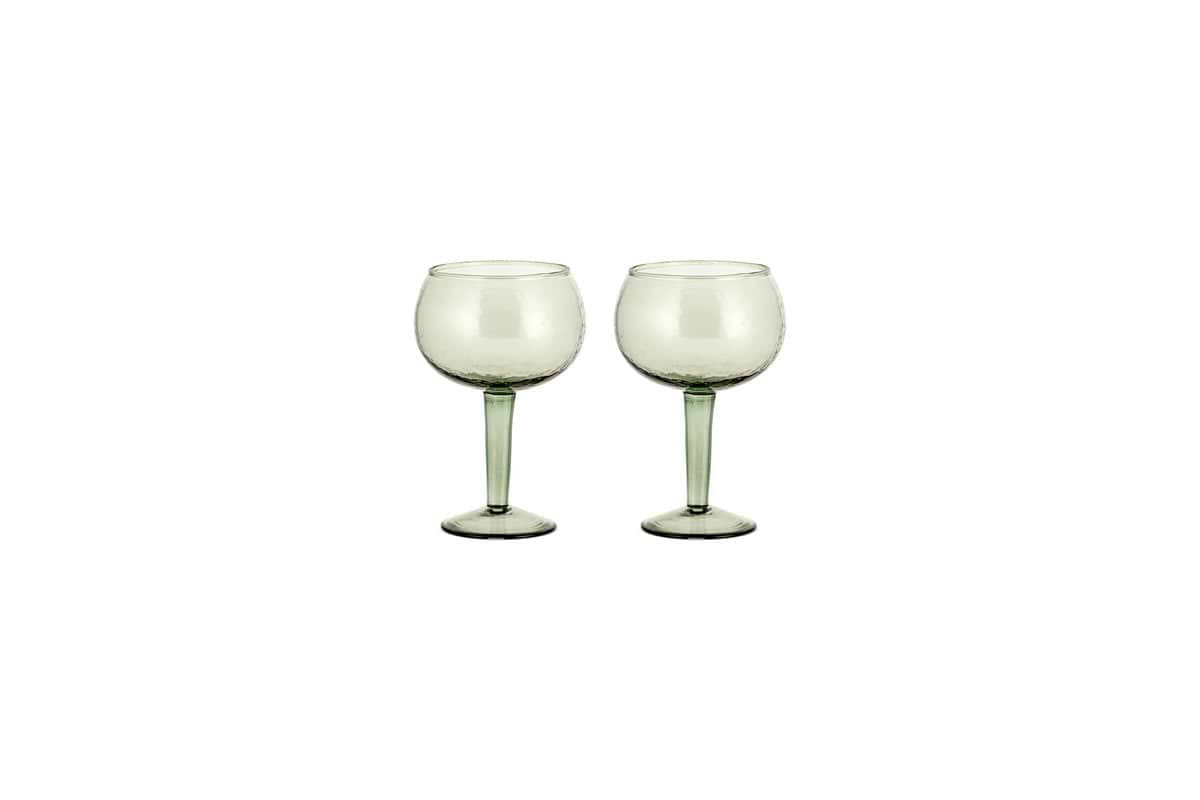 The nkuku Yala Hammered Gin Glass set includes two sage green glasses with long stems, displayed side by side on a white background.