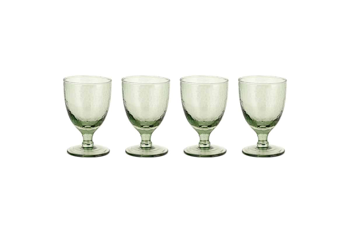 Four sage green Yala Hammered Wine Glasses by nkuku are arranged in a row on a white background. Set of 4.