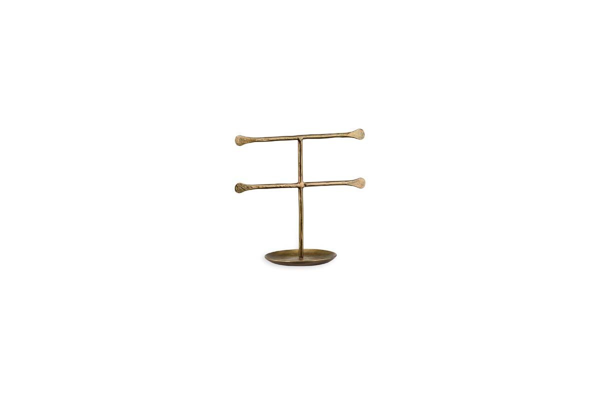 The Liman Jewellery Stand by nkuku features a minimalist brass finish with two horizontal bars on a central rod and a round base, perfect for organizing and displaying necklaces or bracelets in modern style.