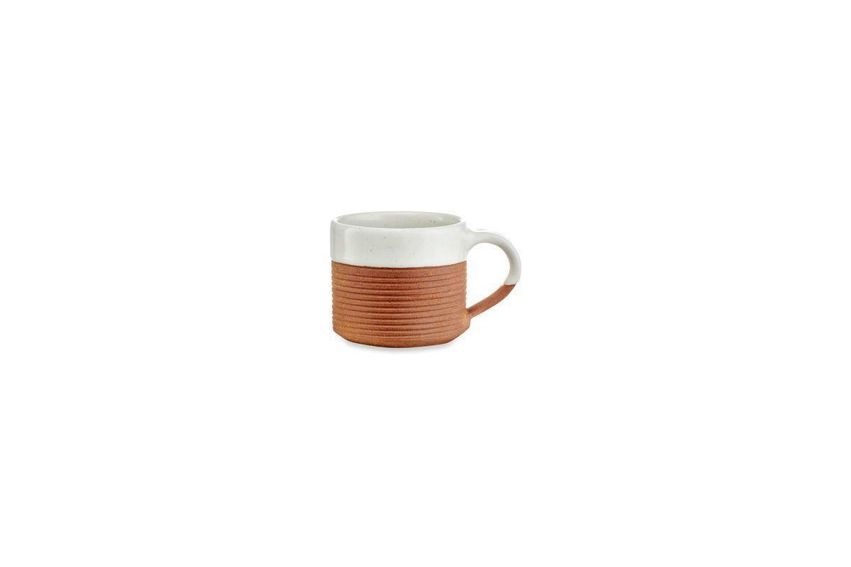 The Mali Ribbed Coffee Mug - White by nkuku features a white, speckled top and textured reddish-brown base with a rounded handle and minimalist design. Sold as a set of 2. Shown on a white background.