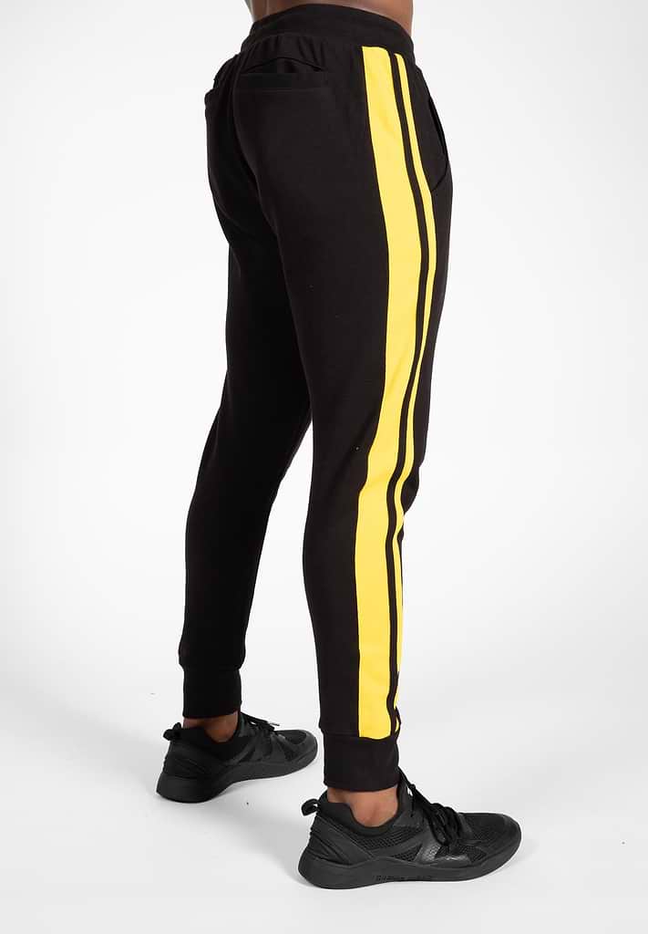 Yellow track pants with black stripe hot sale