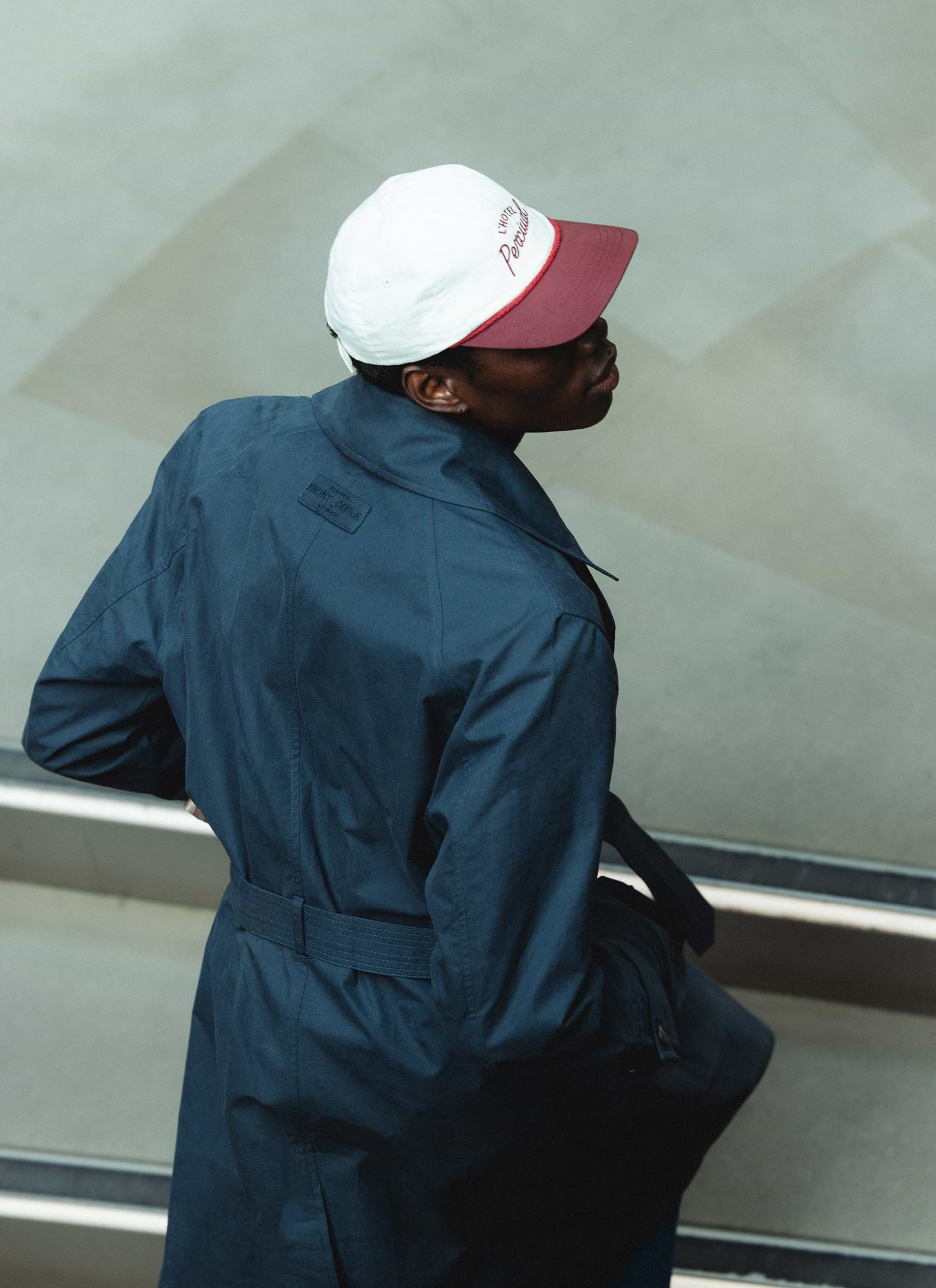 Navy Percival x Front Office Mac Trench Coat in peached cotton, featuring the collaboration tab on the raglan back.