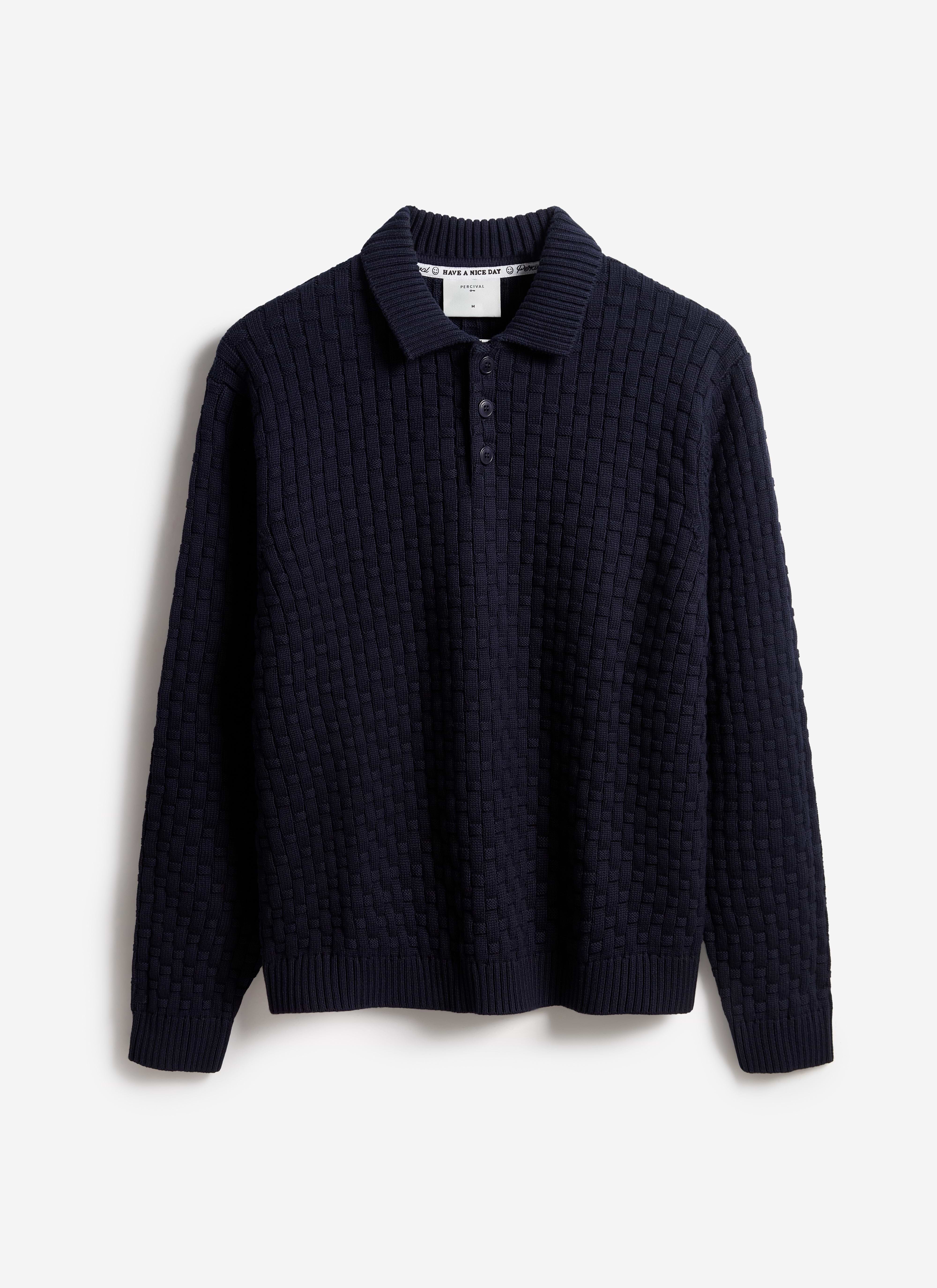 The Percival Archer long-sleeve knitted shirt in navy, featuring a basketweave texture, laid flat on a white background.