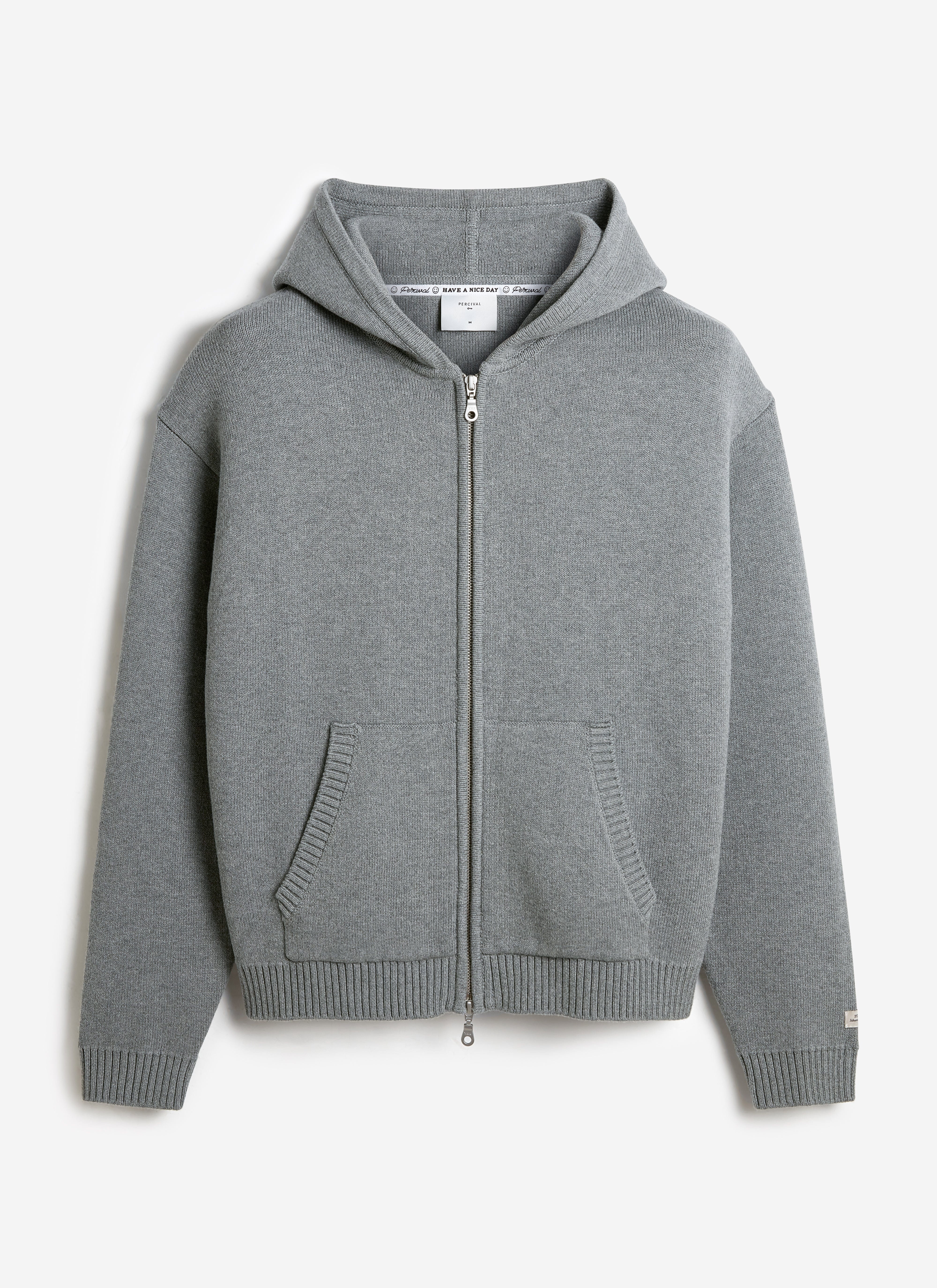 A flat lay of the Percival Chronicle Knitted Hoodie in grey cotton, featuring a zip-up front, hood and kangaroo pockets.