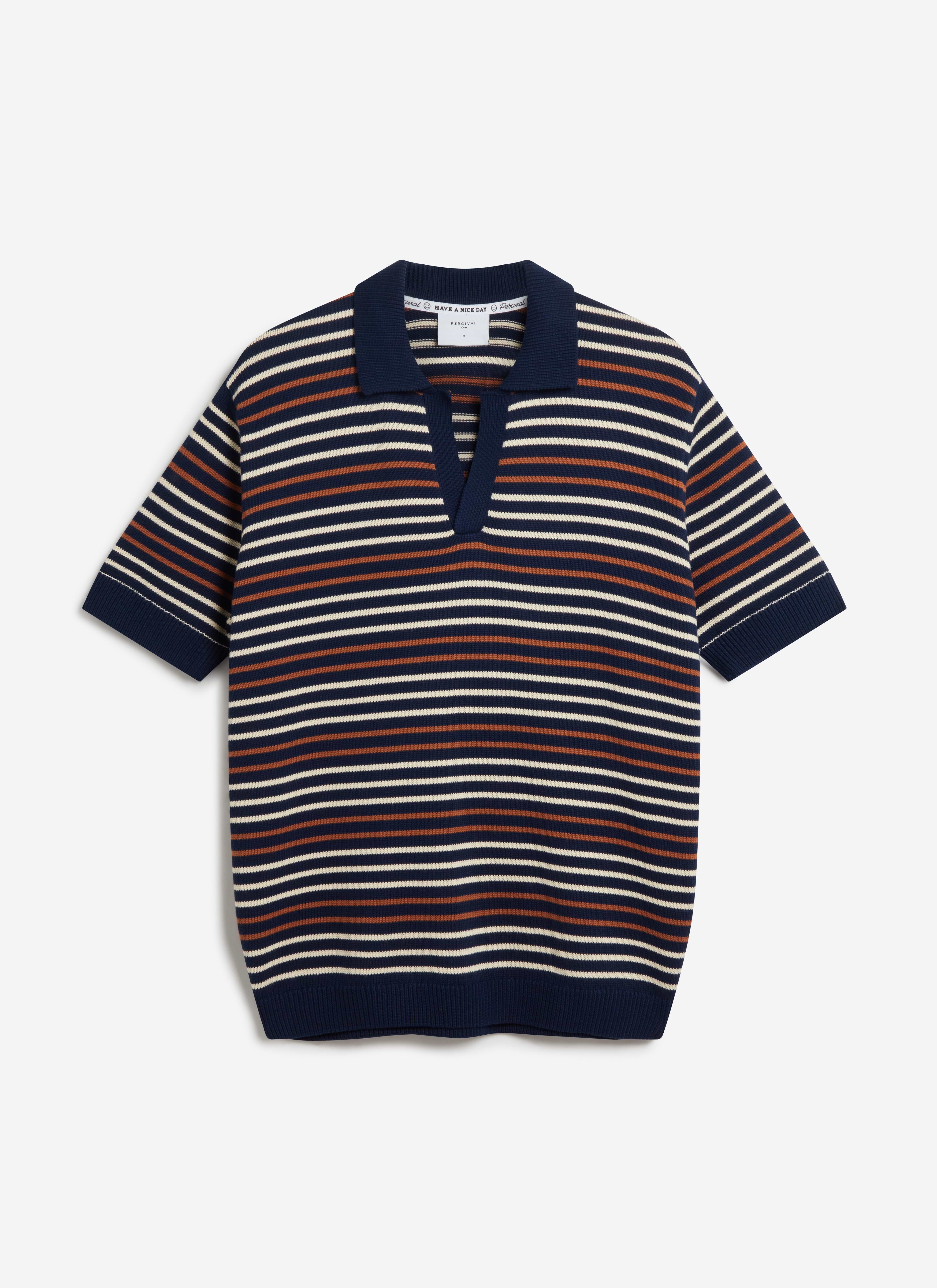 A flat lay of the Percival Douglas Boxy Knitted Polo in navy, featuring an off-white and rust horizontal stripe pattern.