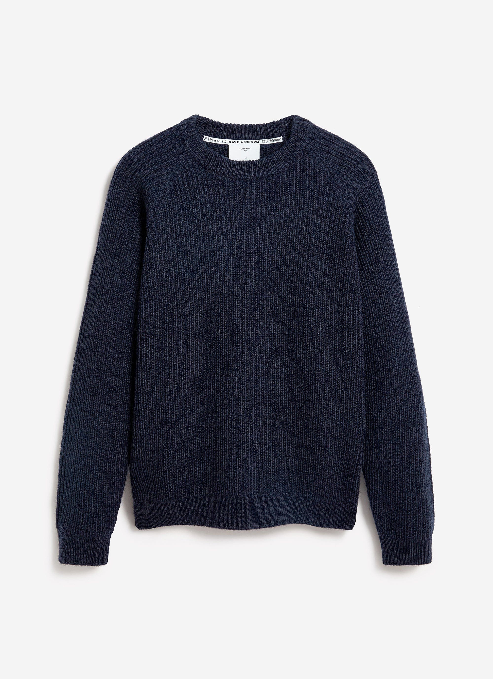 The Percival Fisherman Raglan Jumper in navy blue wool, laid flat against a simple white background.