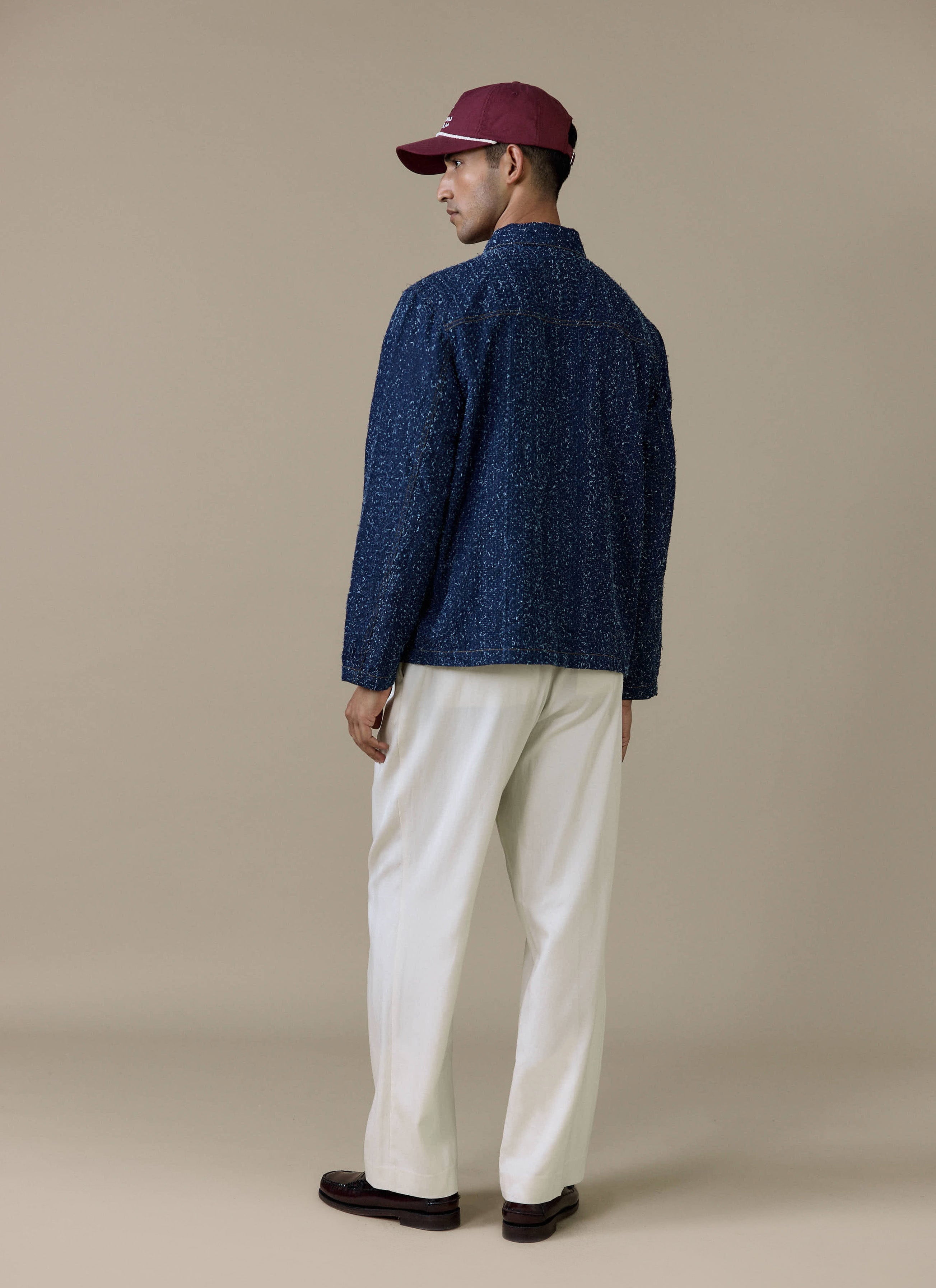 Back view of the navy cotton Parsons Chore Jacket by Percival, showing the textured fabric and contrast stitching.