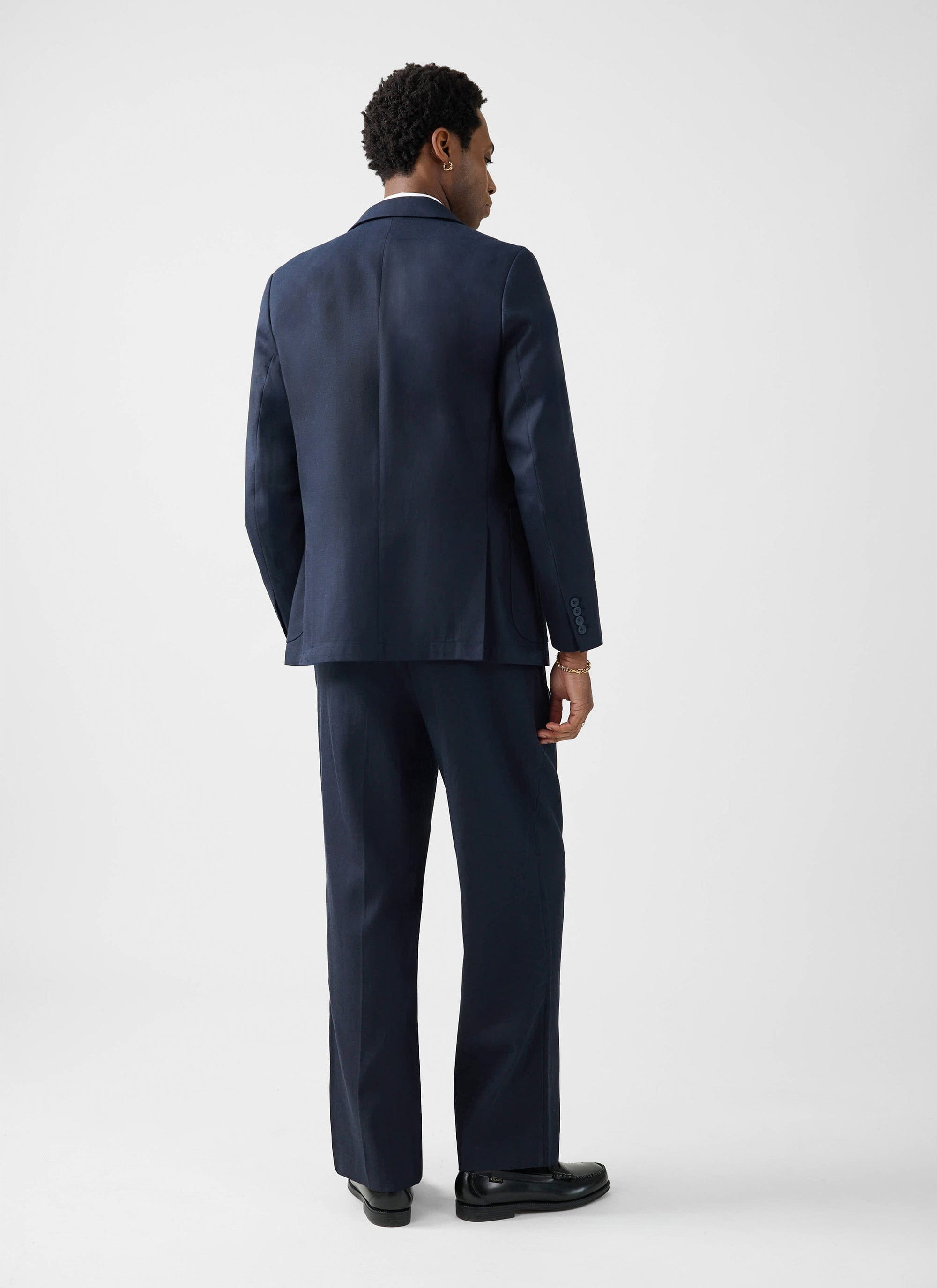 The Percival Lyocell Regular Blazer in navy, modelled from behind to show the regular tailored fit and single vent detail.