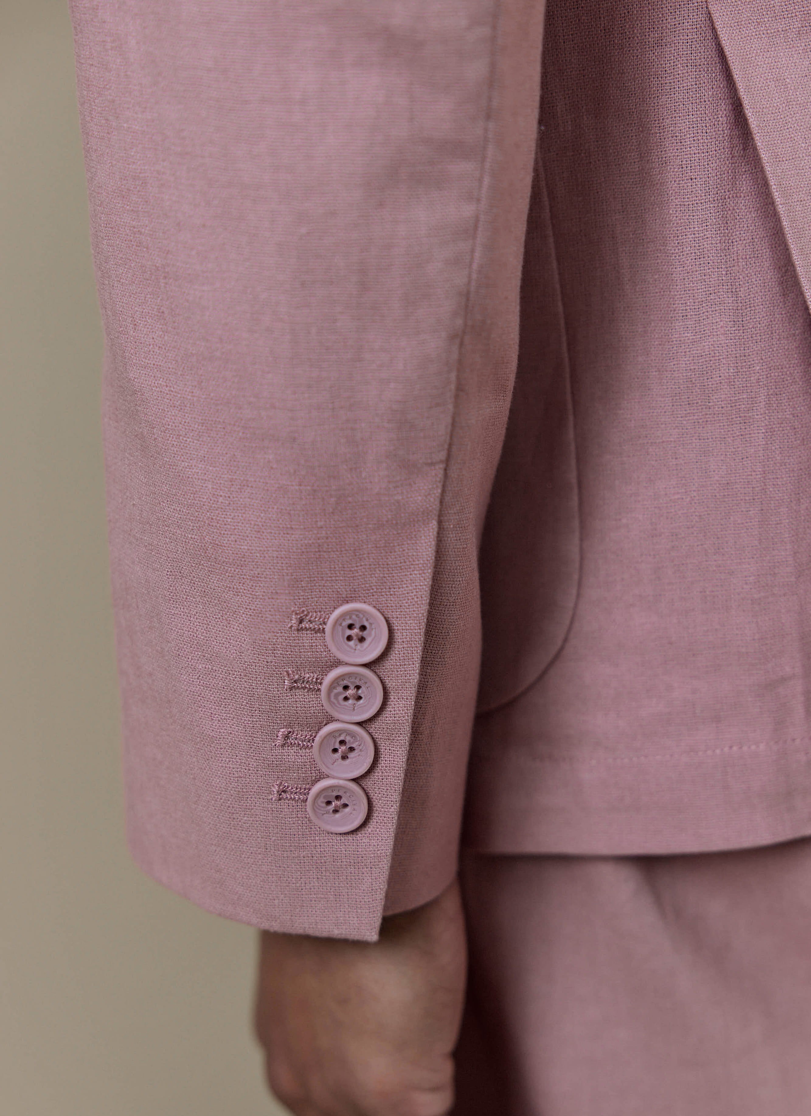 Close-up of the four-button working cuff on the dusty pink Percival Tailored Linen Blazer in a linen-cotton blend.
